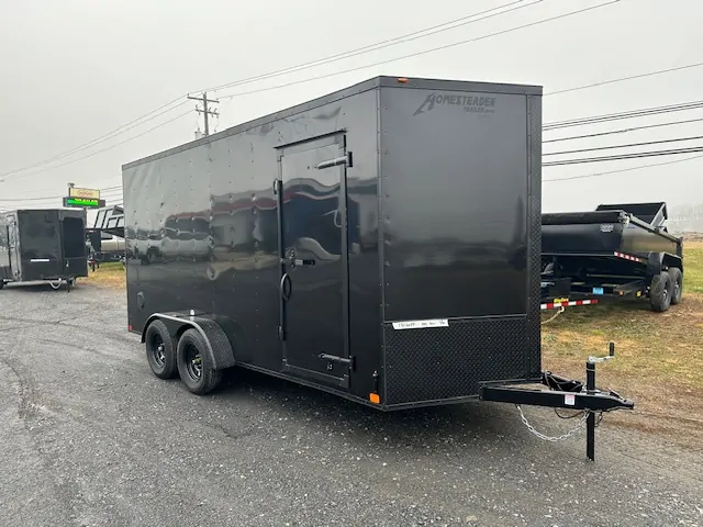 2025-HOMESTEADER-ENCLOSED-CARGO-TRAILER-RAMP-DOOR-ADDED-HEIGHT-BLACK-TRIM-3.webp Homesteader 7 x 16 V-Nose Enclosed Cargo Trailer – Black Trim - Image 1
